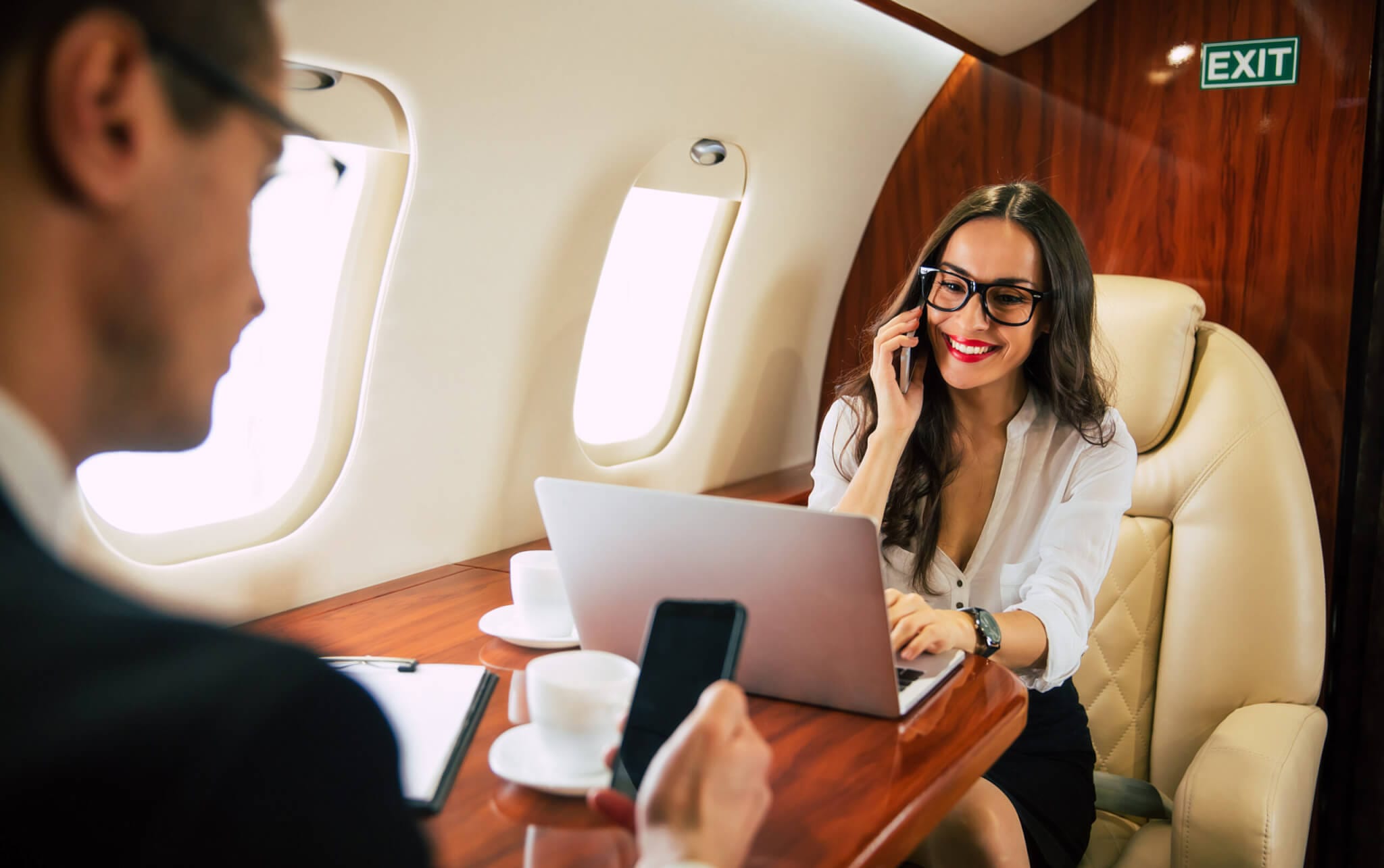 Business personnel aboard private jet