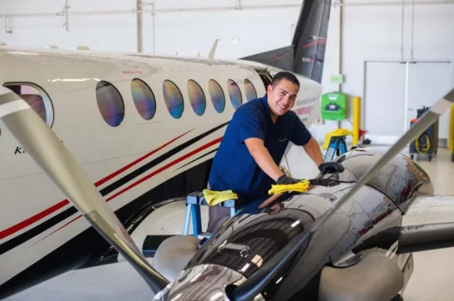 aviation maintenance technician inspecting private jet