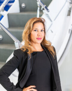 Karen-Romero woman standing in front of the stairs of a private jet
