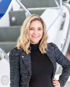 MaKayla-Gorski woman standing in front of the stairs of a private jet