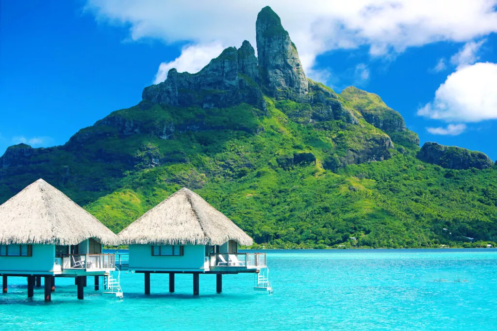 Bora Bora huts in ocean - one of the best places to travel in june