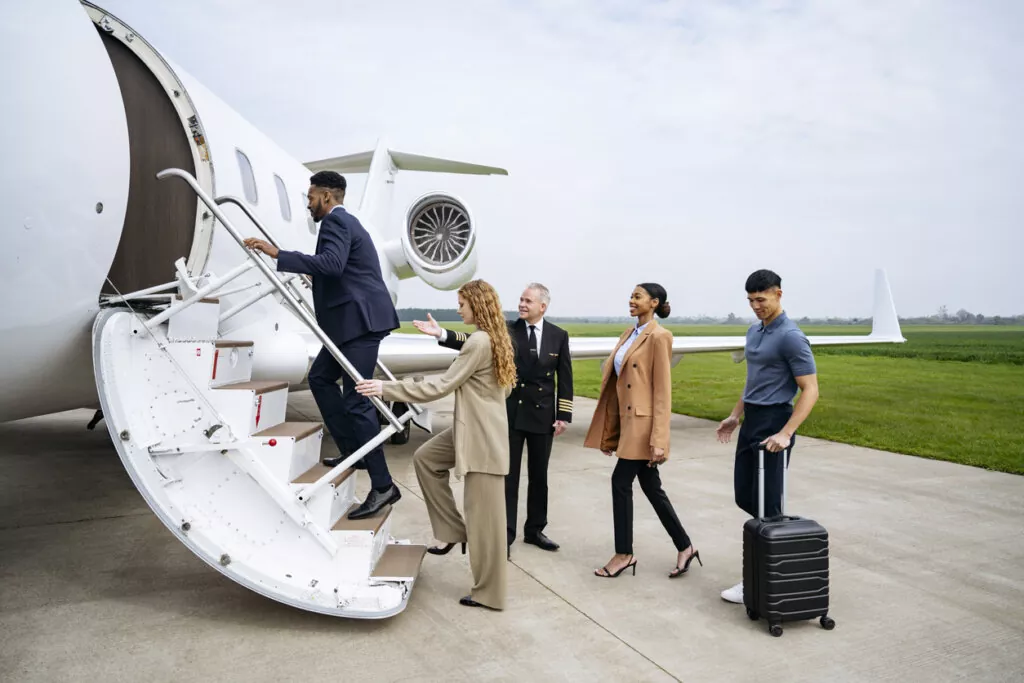 group boarding private jet for luxury corporate retreat